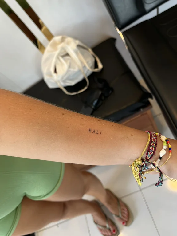 woman colorful sun fine line thin line fire lettering tattoo hand tattoo canggu bali