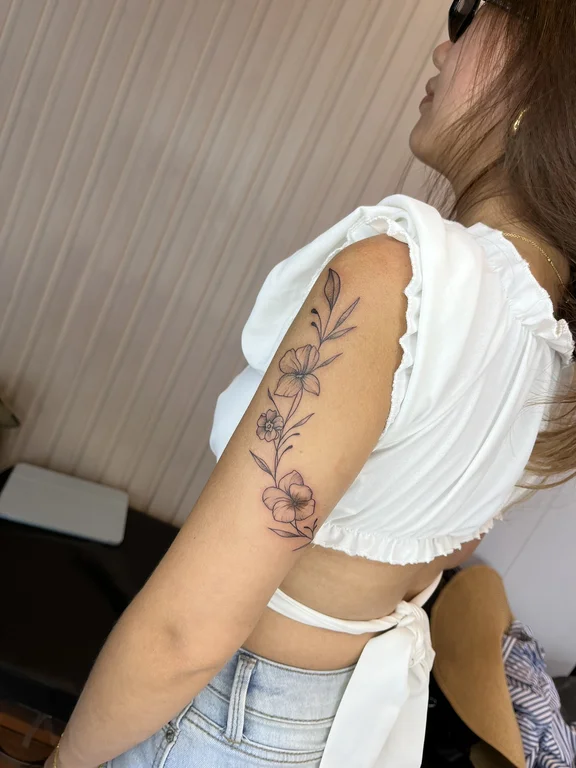 floral fine line woman linework elegant flower minimal soft shading tattoo Canggu Bali