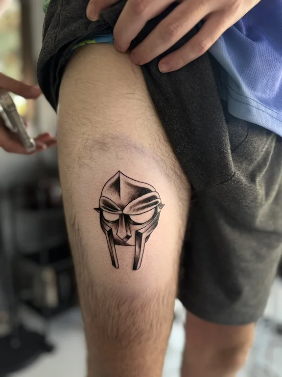 skull blackwork mask black grey minimal heavy shading bold line linework tattoo Canggu Bali