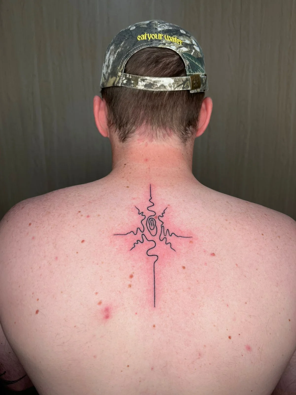 man back tribal abstract fine line line work line spiral tattoo canggu bali