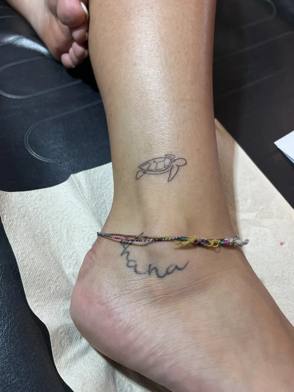 thin line linework spiritual colorful turtle woman foot tattoo canggu bali