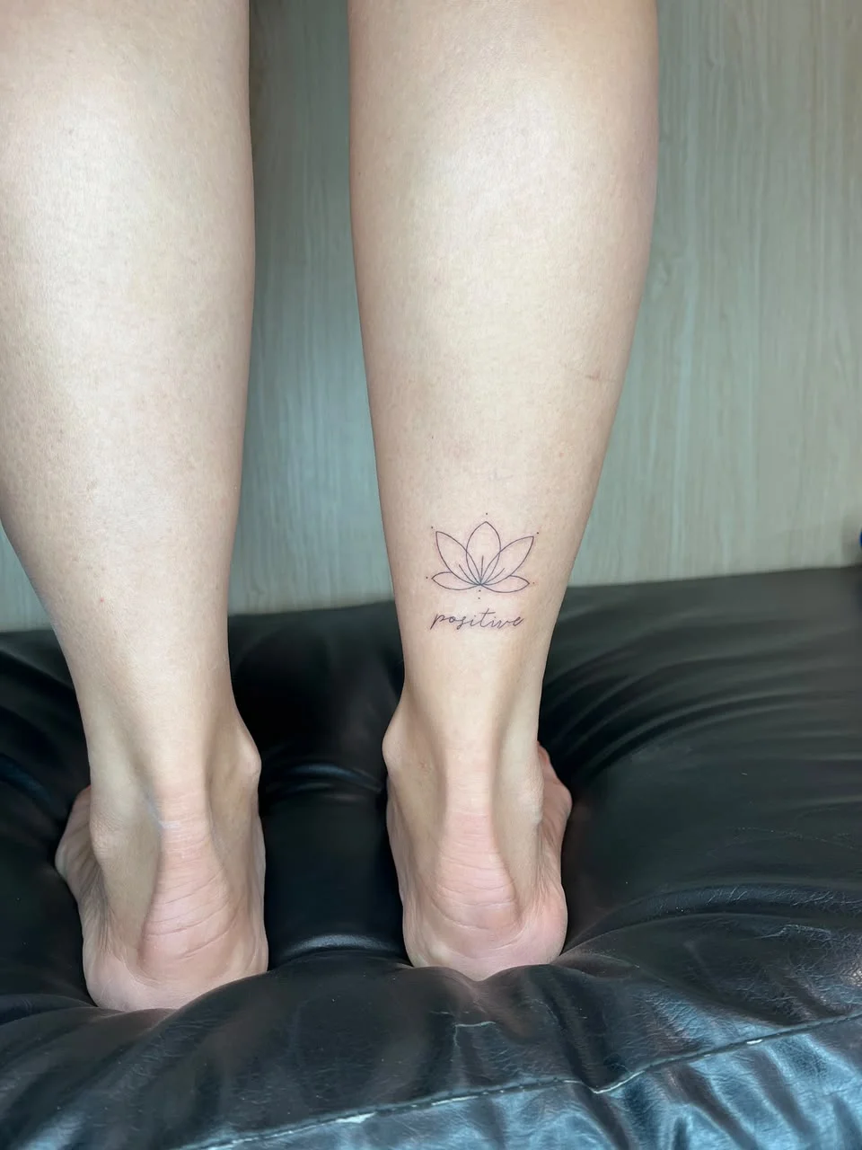 woman foot leg lotus flower fine line line work line tattoo canggu bali