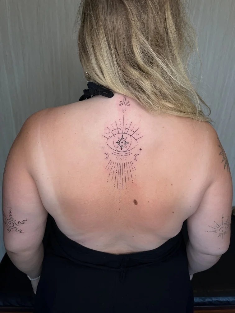 woman back fine line linework line eye geometric elegant tattoo canggu bali