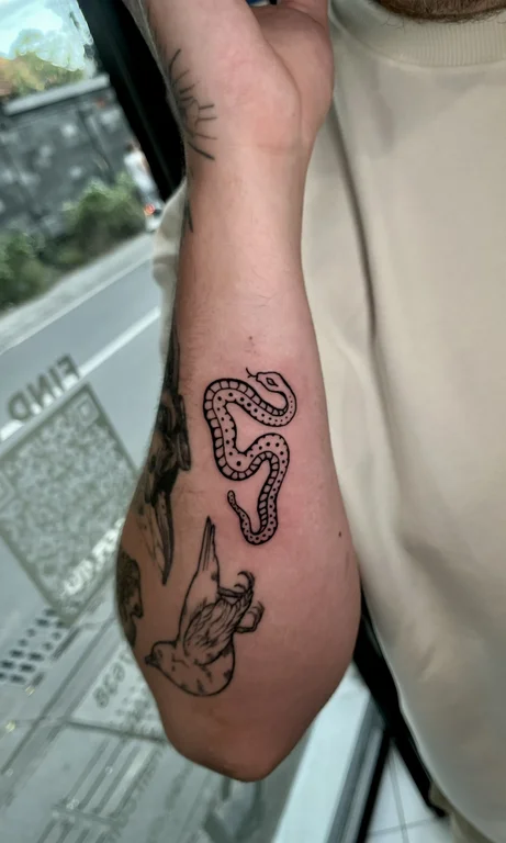 animal blackwork snake dotwork elegant fine line linework bold line tattoo Canggu Bali