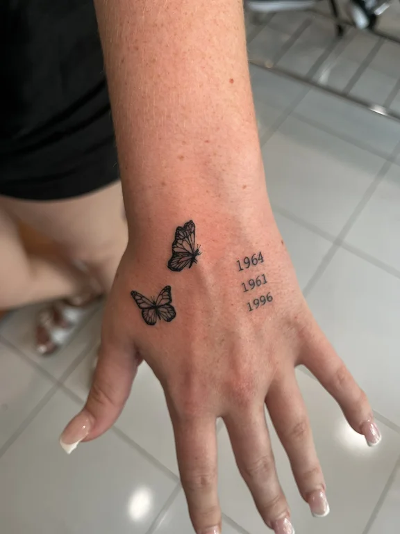 symbol minimalist butterfly black grey elegant fine line soft shading minimal tattoo Canggu Bali