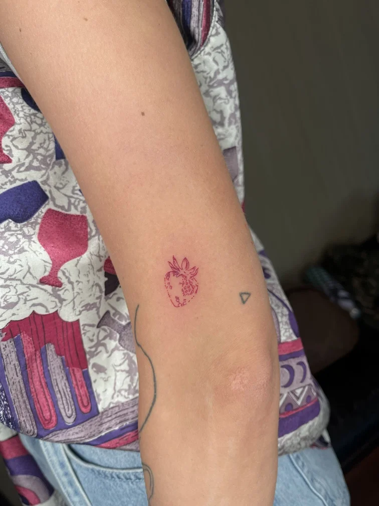strawberry woman hand red fine line fineline linework line minimalist fruit tattoo small tattoo canggu bali