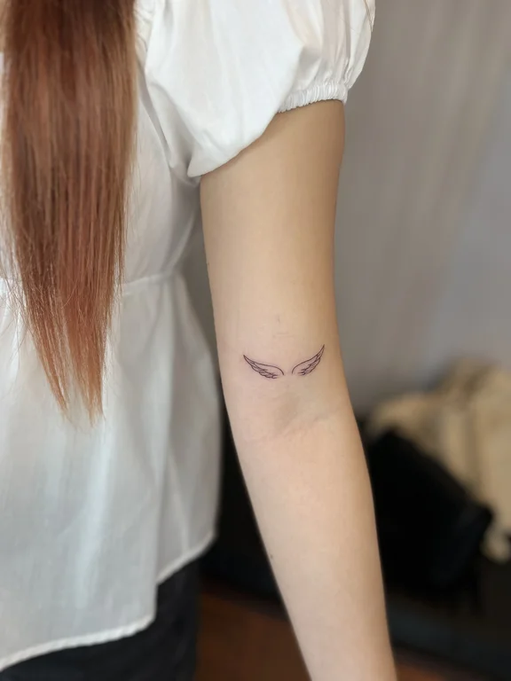 symbol minimalist angel fine line minimal elegant soft shading thin line tattoo Canggu Bali