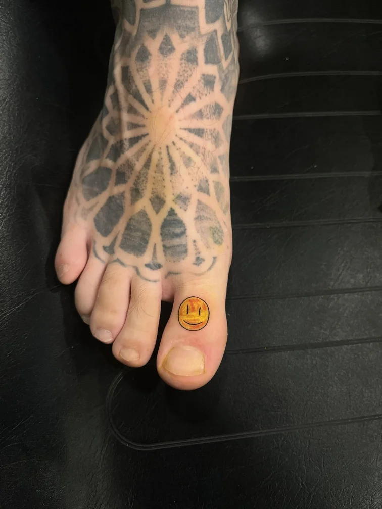 smile man finger color fine line linework line tattoo foot tattoo canggu bali