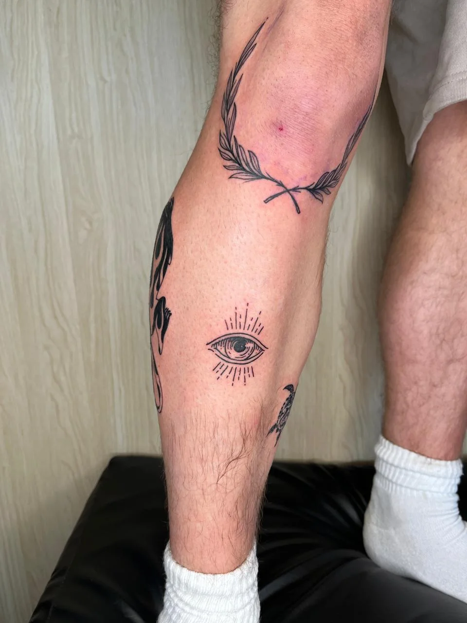 man leg foot eye symbol old school black work tattoo canggu bali